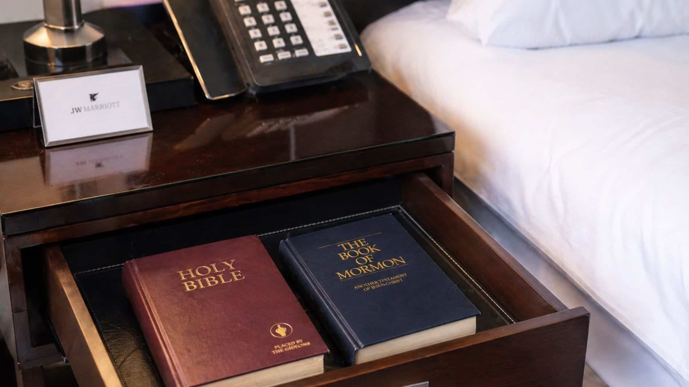 hotel room drawer with bible and book of mormon marriott