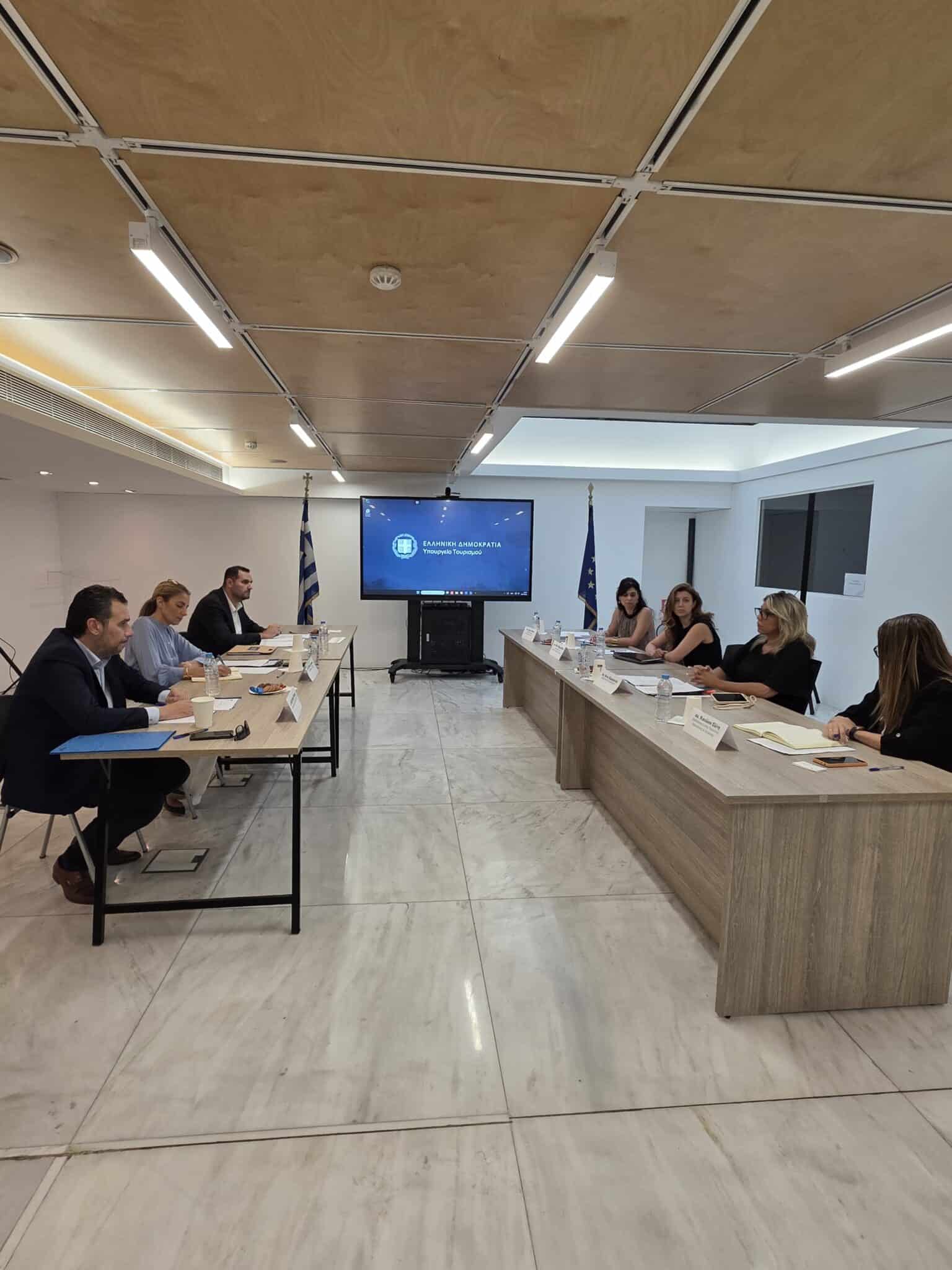 Students and hospitality professionals during practical tourism training in a modern hotel environment in Greece.